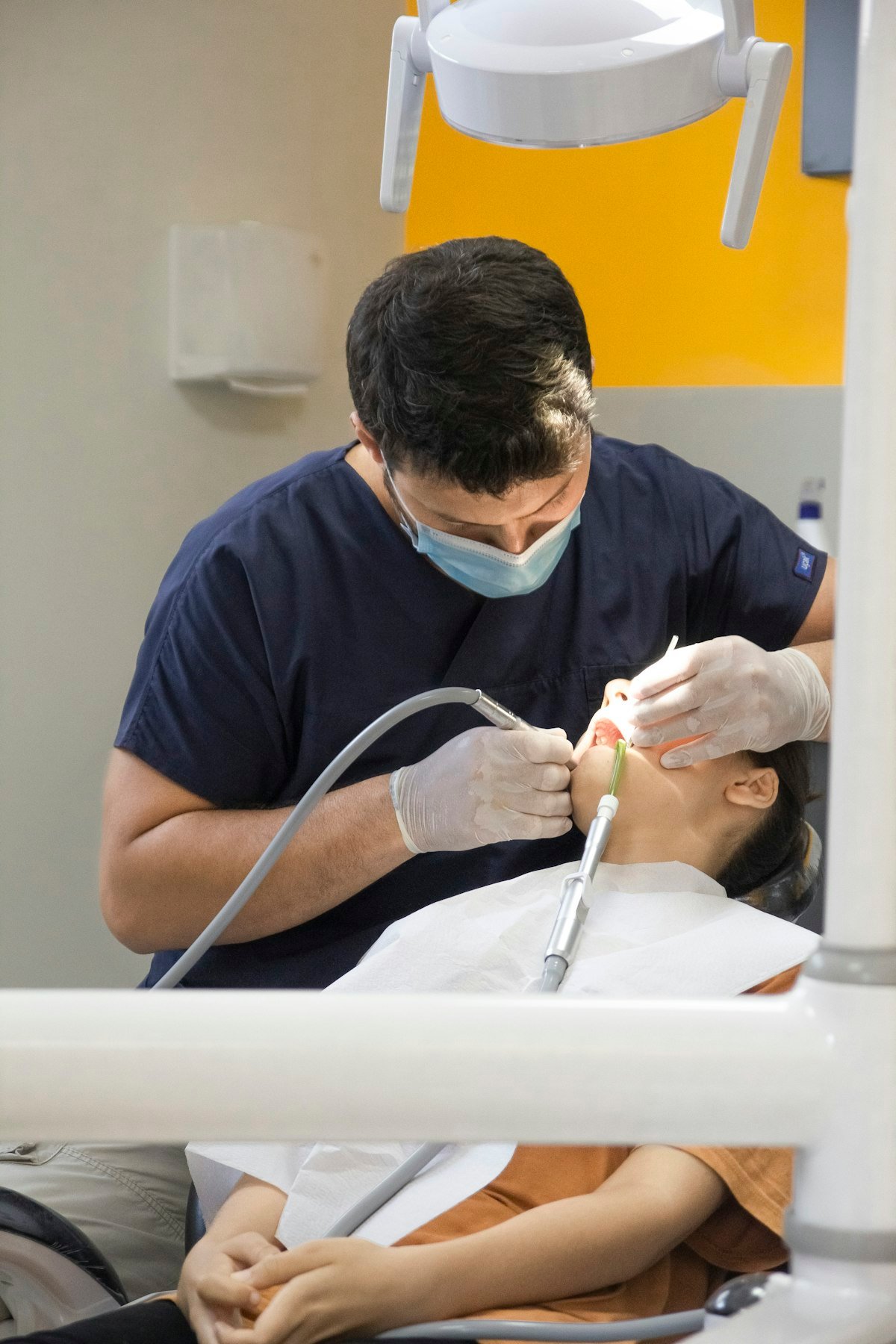 Dental clinician performing a precise procedure with gloved hands
